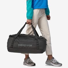 a person carrying a duffel bag on their back with the word patagonia printed on it