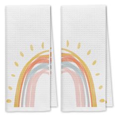 two white towels with rainbows on them