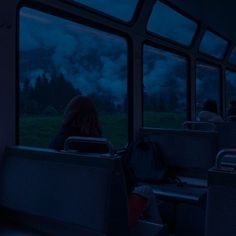 people are riding on a bus at night