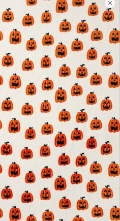 an orange and black pumpkin pattern on a white background with lots of small jack - o'- lanterns