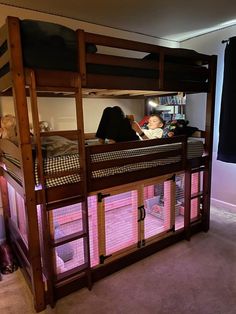 there is a bunk bed with pink lights in the room and two children sleeping on it