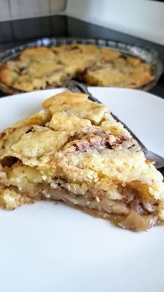 a piece of pie sitting on top of a white plate next to a pie pan