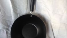 a black frying pan sitting on top of a white sheet