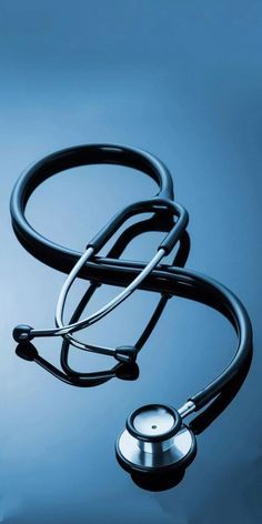 a stethoscope laying on top of a blue surface with water in the background