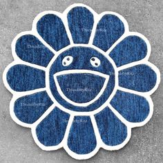 a blue and white flower with eyes on it's face in the shape of a sunflower