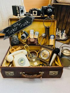 an old suitcase filled with lots of different types of things to put in it's compartment