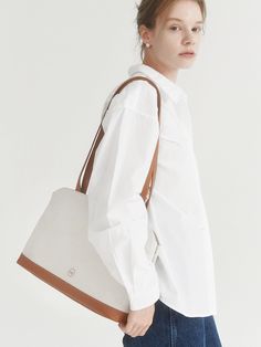 Editor's Notevey presents a bag that can be worn with any style from office look to casual look.- Three dimensional silhouette- Simple designed canvas bag- Good to wear it with thick outer- Inner open pocket and zipper pocketMeasurements (in.)- Size: 13.98 in. * 9.84 in. * 4.13 in.- Strap Length: 0.79 in. * 27.56 in.Composition & Care- Upper: Cotton Canvas, Lining: Cotton- Do not wash- Professional cleaning is neededDesigner- by vey Canvas Satchel With Zipper Pocket For Everyday, Versatile Everyday Bags With Canvas Lining, Versatile Everyday Bag With Canvas Lining, Leather Canvas Bag For Work With Leather Handles, Versatile Canvas Satchel, Versatile Canvas Bag, Versatile Everyday Canvas Satchel Bag, Modern Canvas Bag With Zipper Pocket For Everyday, Beige Canvas Bag With Zipper Pocket