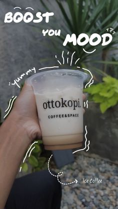 a person holding up a coffee cup with the words, boost you mood