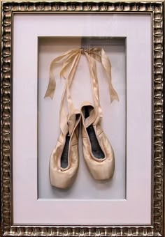 a pair of ballet shoes in a frame