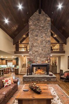 the living room has a stone fireplace in it