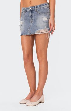 Online Only! Make a statement and command the room with the Ginnie Low Rise Distressed Denim Mini Skirt! Flaunting a low-rise waist and edgy distressed detailing, this skirt is crafted from denim fabric, offering both style and comfort. Complete with a raw edge hem, it's the perfect piece to elevate your casual chic look.


	Mini skirt
	Low rise waist
	Distressed detailing
	Raw edge hem
	Denim fabric
	100% Cotton
	Model wears size S
	Model height is 5'7
	Item care: Wash with similar color Ripped High Waist Fitted Mini Skirt, Ripped High-waist Fitted Mini Skirt, Fitted Ripped Mini Bottoms, Ripped Fitted High Waist Mini Skirt, High Waist Ripped Fitted Mini Skirt, Fitted Ripped Bottoms In Mini Length, Ripped Fitted Denim Mini Skirt, Fitted Distressed Medium Wash Mini Skirt, Ripped Fitted Cutoff Mini Skirt