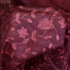 an image of a purple and pink fabric with flowers on it, close up view