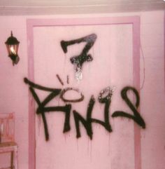 graffiti is spray painted on the wall next to a door