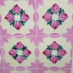 four pink roses painted on white tiles with green leaves in the center and bottom part