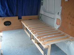 the inside of a camper van with a bed attached to it's side