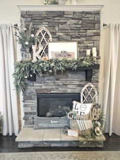 a living room with a stone fireplace decorated for christmas