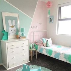 a child's bedroom decorated in pastel colors