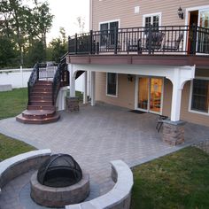 an outdoor patio with fire pit and stairs