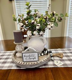 a vase with flowers on top of a table