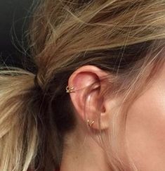 a close up of a person wearing ear piercings