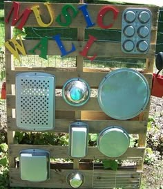 a sign made out of wooden pallets with different types of cooking utensils