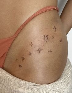 the back of a woman's stomach with stars on it