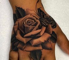 a hand with a rose and butterfly on it