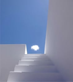 white stairs leading up to a bright blue sky