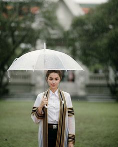 a woman holding an umbrella in the rain