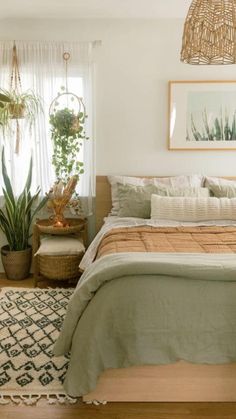 a bedroom with a bed, rug and plants in it