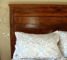 a wooden headboard with two pillows on it