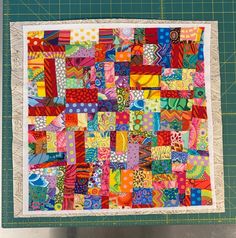 a patchwork quilt on a cutting board