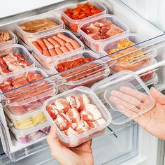 a refrigerator door is filled with plastic containers containing different food items and hands reaching for one container