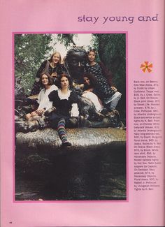 a group of people sitting on top of a log