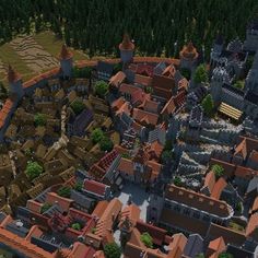 an aerial view of a city with lots of red roofs and tall trees in the background