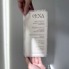 a person holding up a piece of paper with the word gena written on it