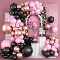 a pink rose surrounded by black and gold balloons