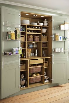 an open cabinet in a kitchen with lots of cupboard space