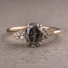 salt and pepper diamond Salt And Pepper Oval Engagement Ring, Black Speckled Diamond Ring, Salt And Pepper Diamond Ring Oval, Oval Salt And Pepper Engagement Ring, Asymmetrical Engagement Ring, Gold Band Diamond Ring, Ring Inspiration, Black Engagement Ring, Oval Diamond Engagement