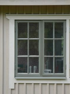 two windows on the side of a house