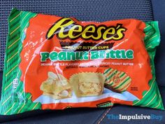 a bag of reese's peanut butter bites sitting on top of a blue chair