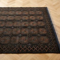 an old rug is laying on the floor in a room with wooden floors and parquets