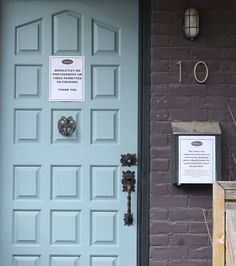 a blue door with a sign on it