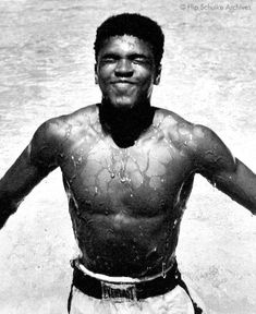 a black and white photo of a man standing in the water