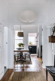 a dining room table and chairs in front of a window