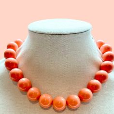 Elevate your style with our Chunky Coral Beaded Necklace! This vibrant choker features big, eye-catching beads, perfect for making a statement. Customize in your favorite colors for a personal touch. Perfect for any occasion, this large bead necklace adds a bold, authentic flair to your look. Order yours today! Introducing our vibrant and eye-catching large beaded necklace! This stunning piece is meticulously handcrafted with colorful 20mm acrylic beads, strung on strong elastic for a comfortable fit. The knot is reinforced with jewelers glue, ensuring durability and longevity. With a variety of lengths to choose from, you can find the perfect fit for your style.  *I want you to love your necklace. Please contact me if you have any concerns. **We can make a necklace in any combination of c Coral Beaded Necklaces With Large Beads, Large Bead Necklace, Coral Beads Necklace, Coral Beads, Unisex Jewelry, Beaded Choker, Acrylic Beads, Statement Jewelry, Favorite Color