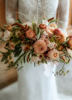 a bride holding a bouquet of flowers in her hands