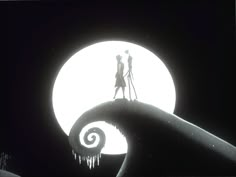 the silhouettes of two people standing on top of a wave in front of a full moon