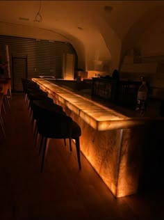 a dimly lit bar with stools and tables