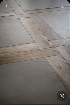 the floor is made out of wood and has grey tiles on it, as well as white